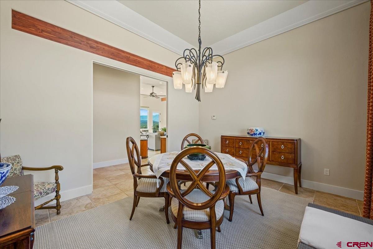 555 Waterview Lane Ridgway, CO 81432 - Photo 13 of 44 a view of a dining room with furniture and chandelier