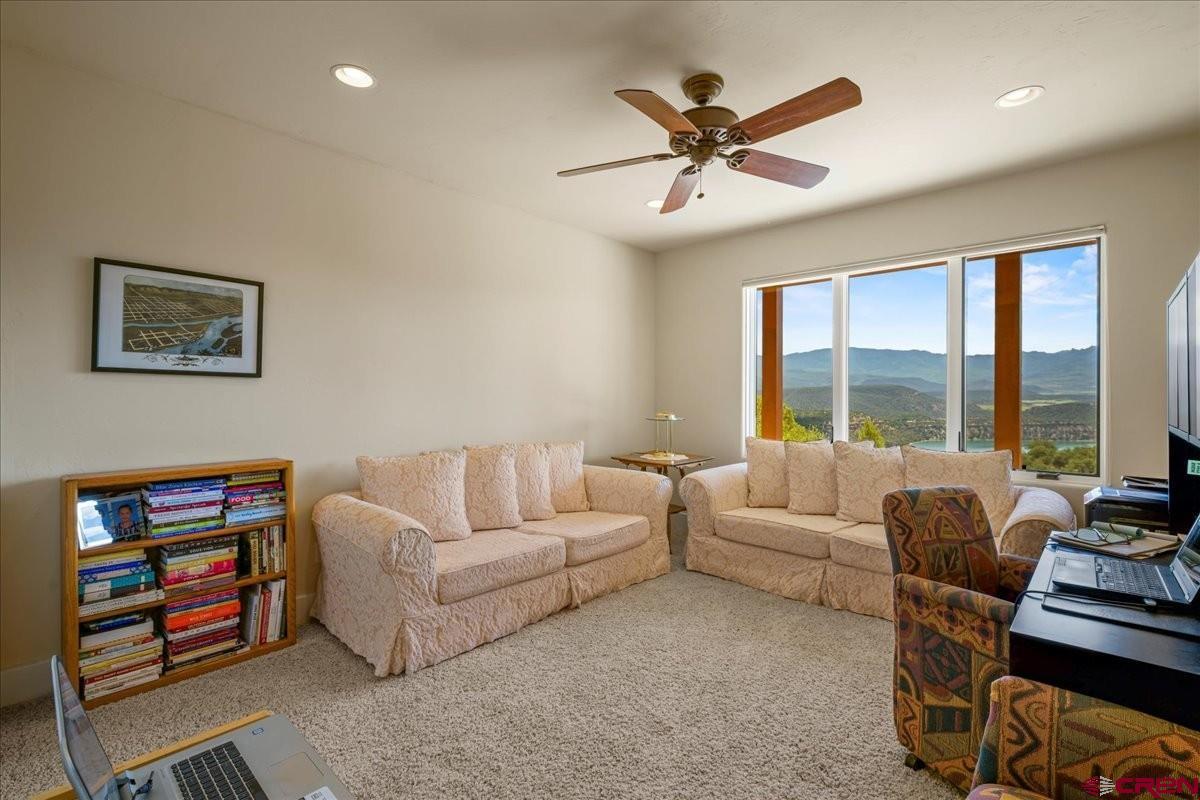 555 Waterview Lane Ridgway, CO 81432 - Photo 28 of 44 a living room with furniture a large window and a chandelier