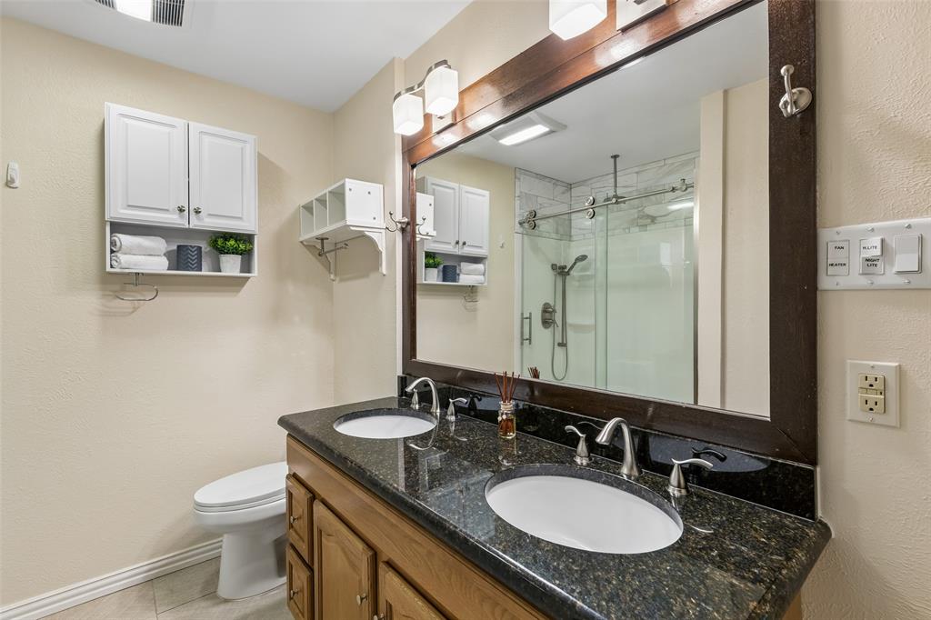 1548 Timbercreek Drive Howe, TX 75459 - Photo 20 of 24 a bathroom with a granite countertop sink toilet and shower