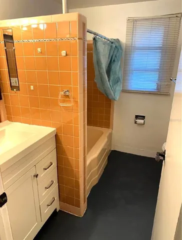 a bathroom with a bathtub and a sink