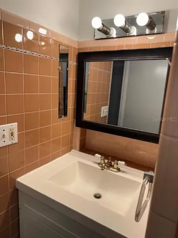 a bathroom with a sink a vanity and a mirror