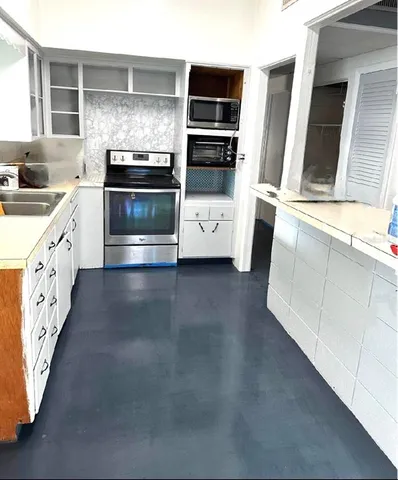 a kitchen with stainless steel appliances granite countertop a stove and a sink