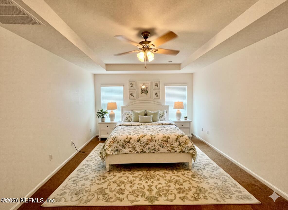 16264 Tisons Bluff Road Jacksonville, FL 32218 - Photo 15 of 36 a bedroom with a bed and a chandelier