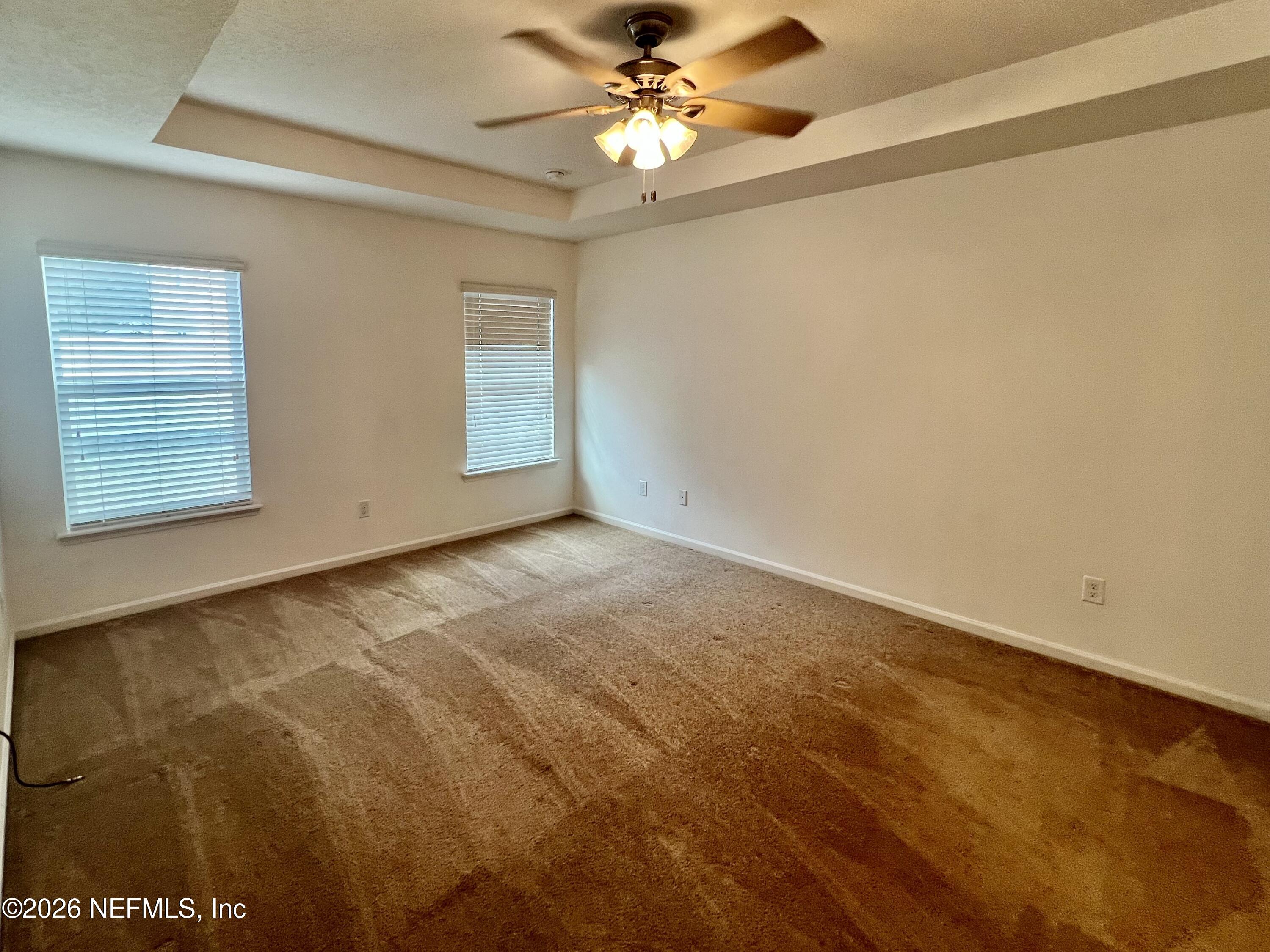 16264 Tisons Bluff Road Jacksonville, FL 32218 - Photo 16 of 36 an empty room with a window and a ceiling fan