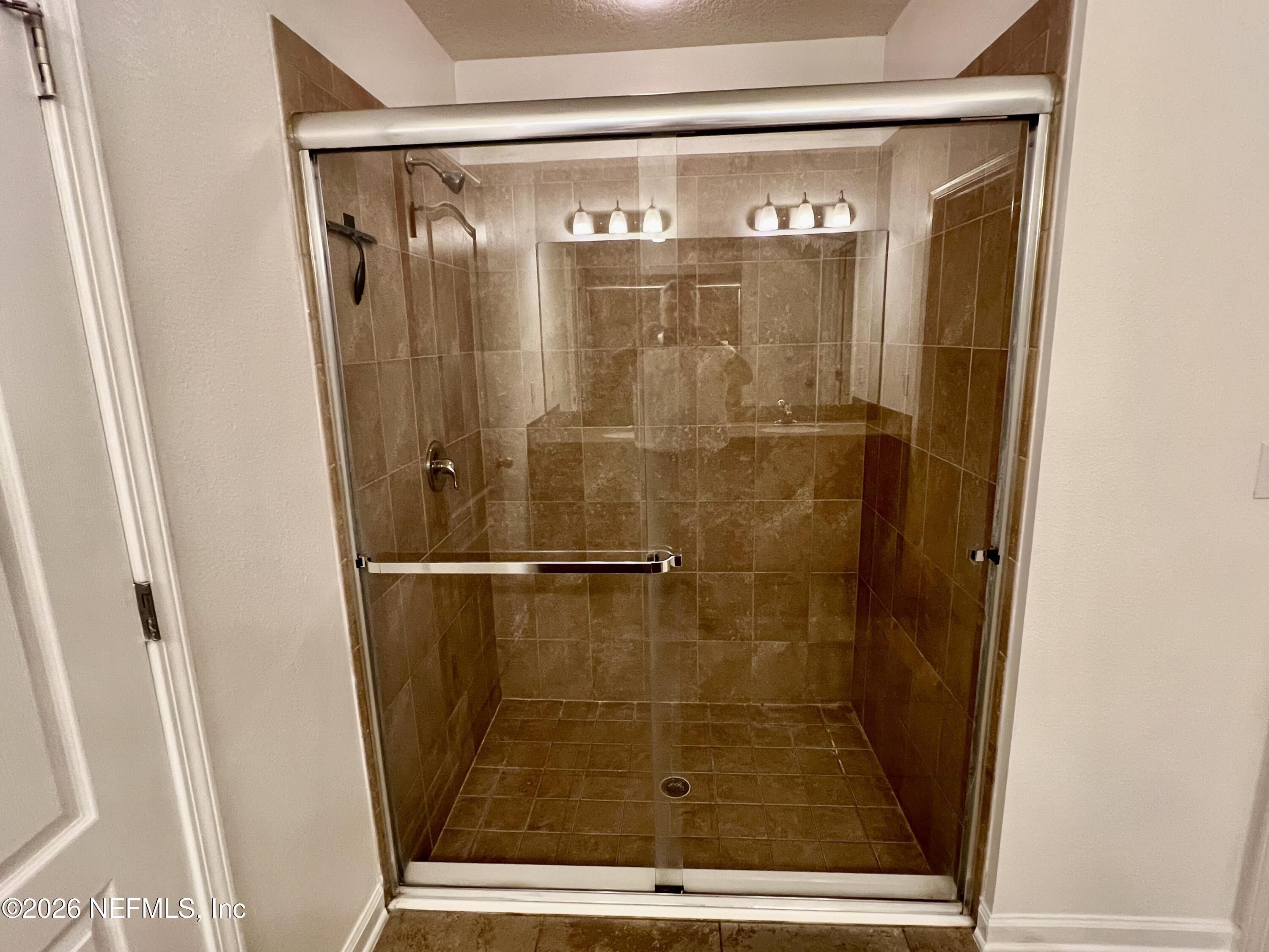 16264 Tisons Bluff Road Jacksonville, FL 32218 - Photo 18 of 36 a bathroom with a glass shower door