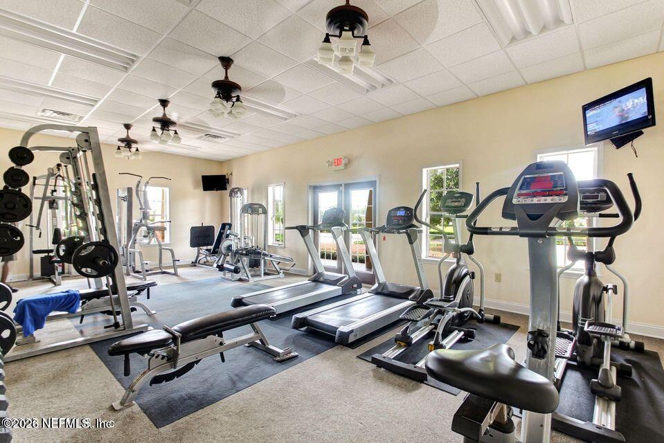 16264 Tisons Bluff Road Jacksonville, FL 32218 - Photo 27 of 36 a room with gym equipment and mirror on the wall