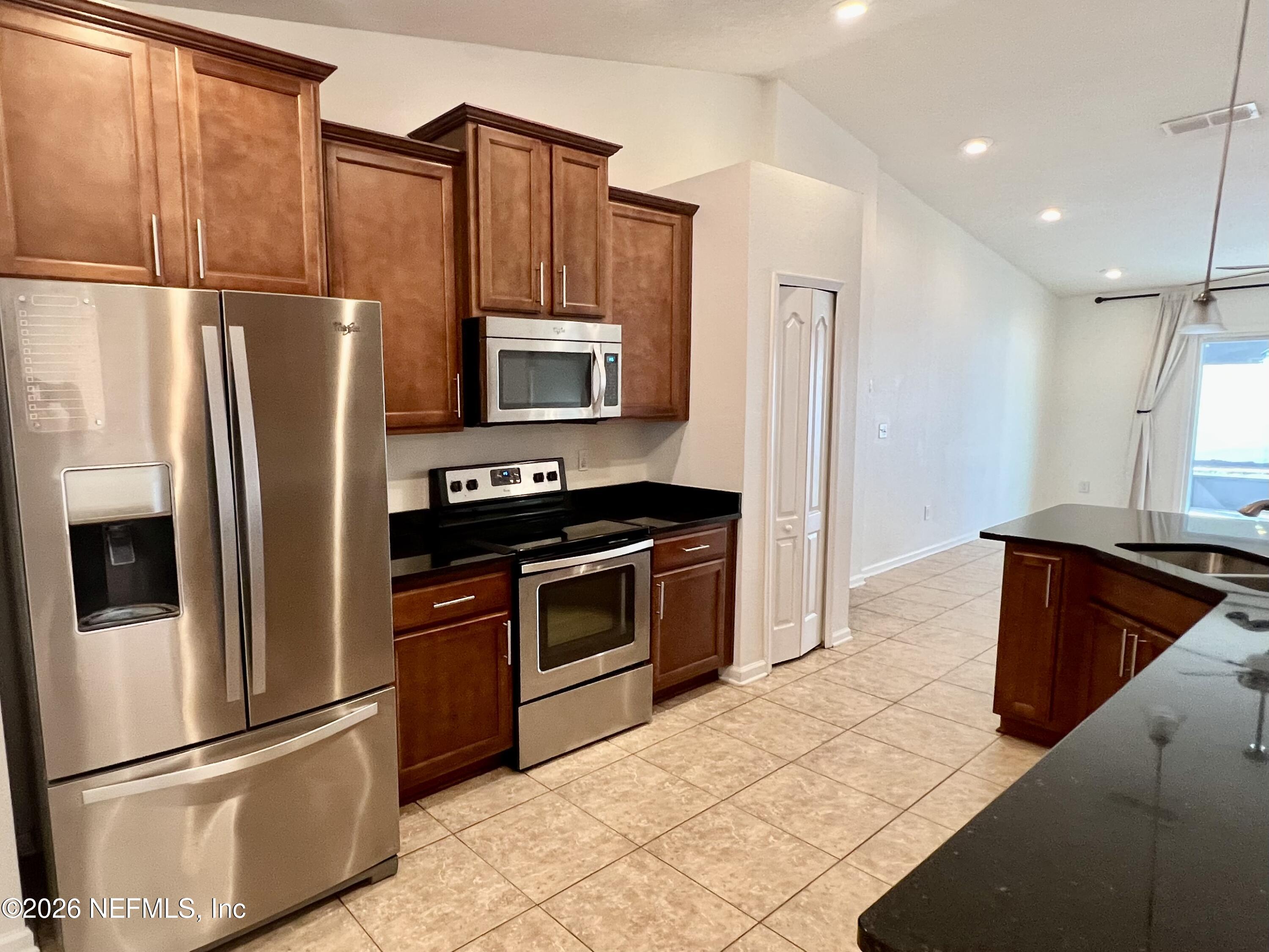16264 Tisons Bluff Road Jacksonville, FL 32218 - Photo 7 of 36 a kitchen with stainless steel appliances granite countertop a refrigerator stove and microwave