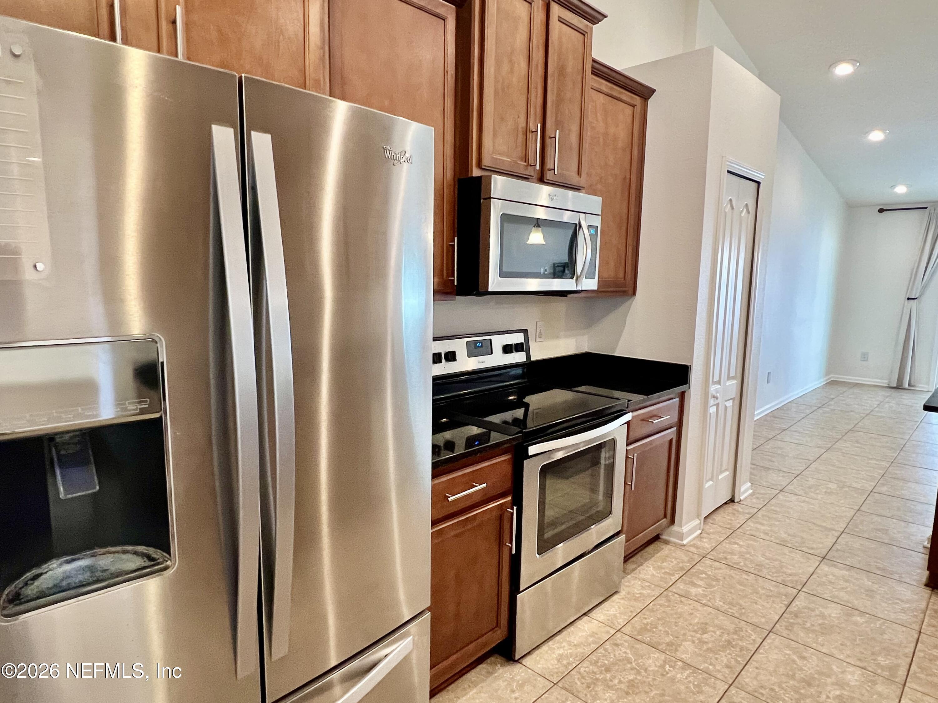 16264 Tisons Bluff Road Jacksonville, FL 32218 - Photo 9 of 36 a kitchen with stainless steel appliances granite countertop a refrigerator stove and microwave