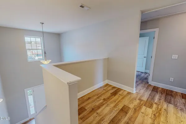 a view of a livingroom with a ceiling fan and wooden floor