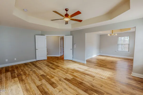 a view of empty room with wooden floor