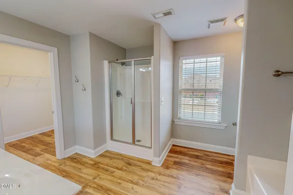 a bathroom with a bathtub and a shower