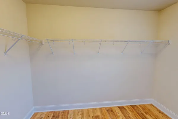 a spacious bathroom with a granite countertop sink a mirror and a shower
