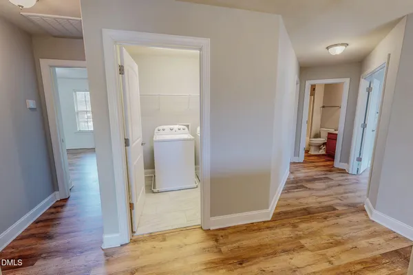 a view of an empty room and wooden floor