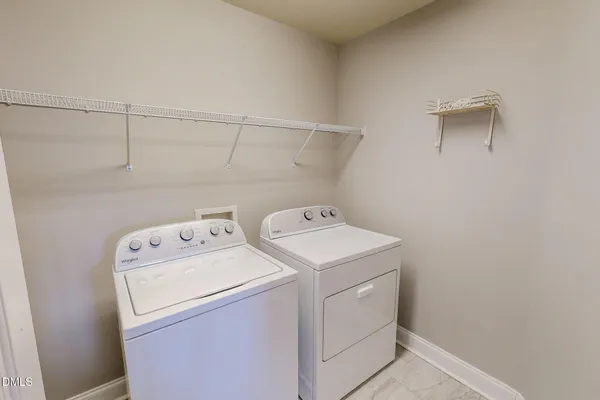 a view of an empty room with wooden floor and closet