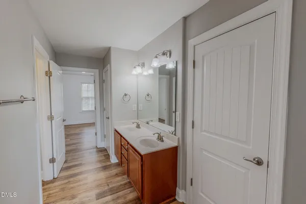 a view of a hallway with wooden floor