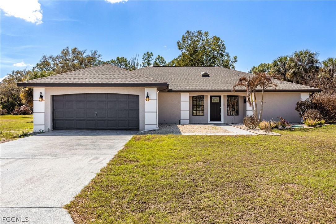 18890 Fox Run Road Alva, FL 33920 - Photo 1 of 50 a front view of a house with a yard