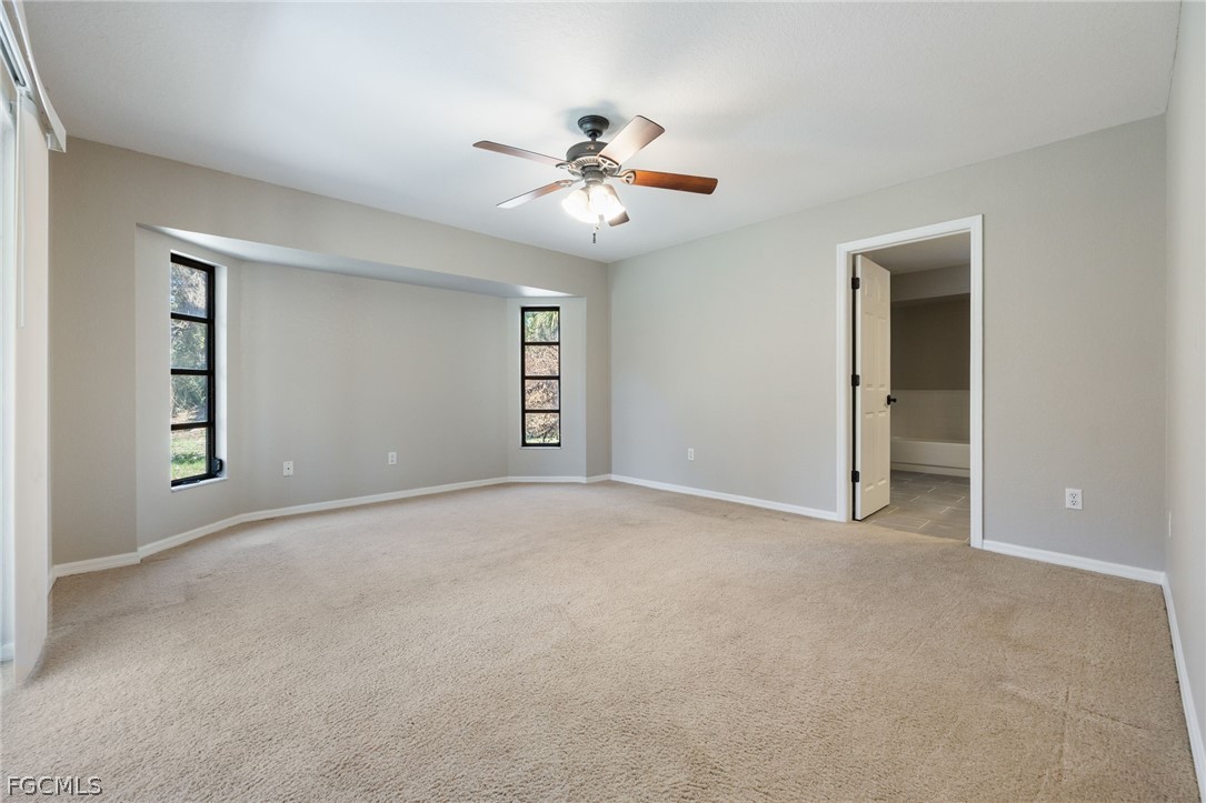 18890 Fox Run Road Alva, FL 33920 - Photo 15 of 50 an empty room with windows and ceiling fan