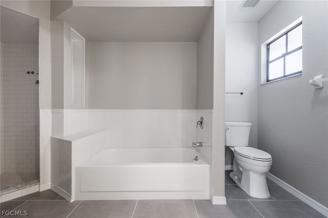 18890 Fox Run Road Alva, FL 33920 - Photo 18 of 50 a white bath tub sitting next to a white toilet