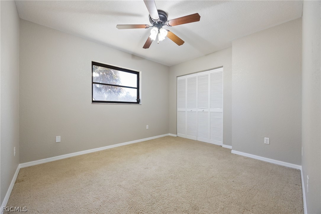 18890 Fox Run Road Alva, FL 33920 - Photo 20 of 50 an empty room with windows and fan