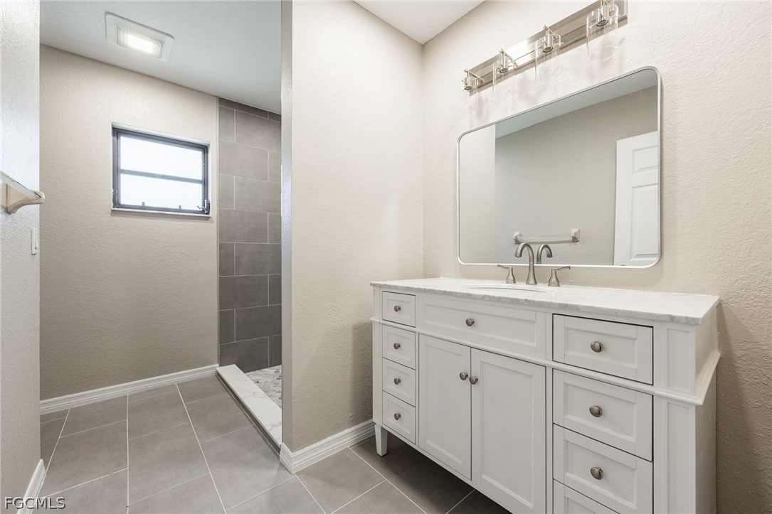 18890 Fox Run Road Alva, FL 33920 - Photo 22 of 50 a bathroom with a sink a vanity and a mirror