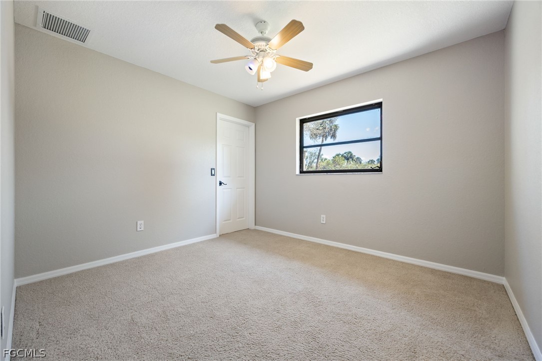 18890 Fox Run Road Alva, FL 33920 - Photo 24 of 50 an empty room with a window and a ceiling fan