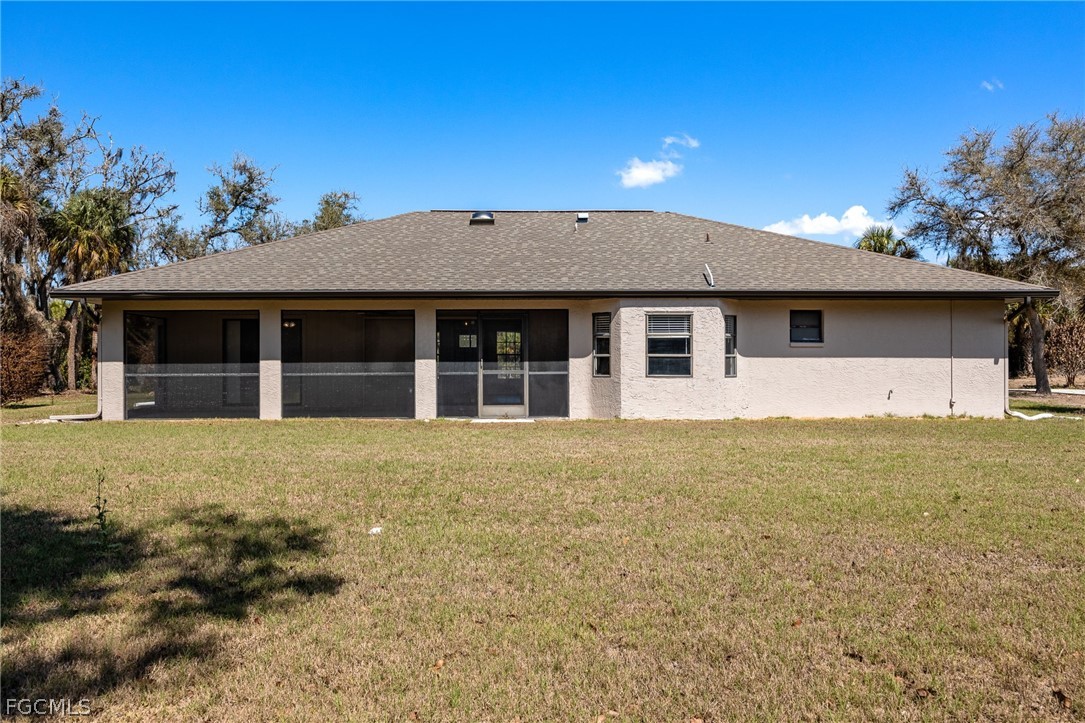 18890 Fox Run Road Alva, FL 33920 - Photo 29 of 50 a front view of a house with a garden