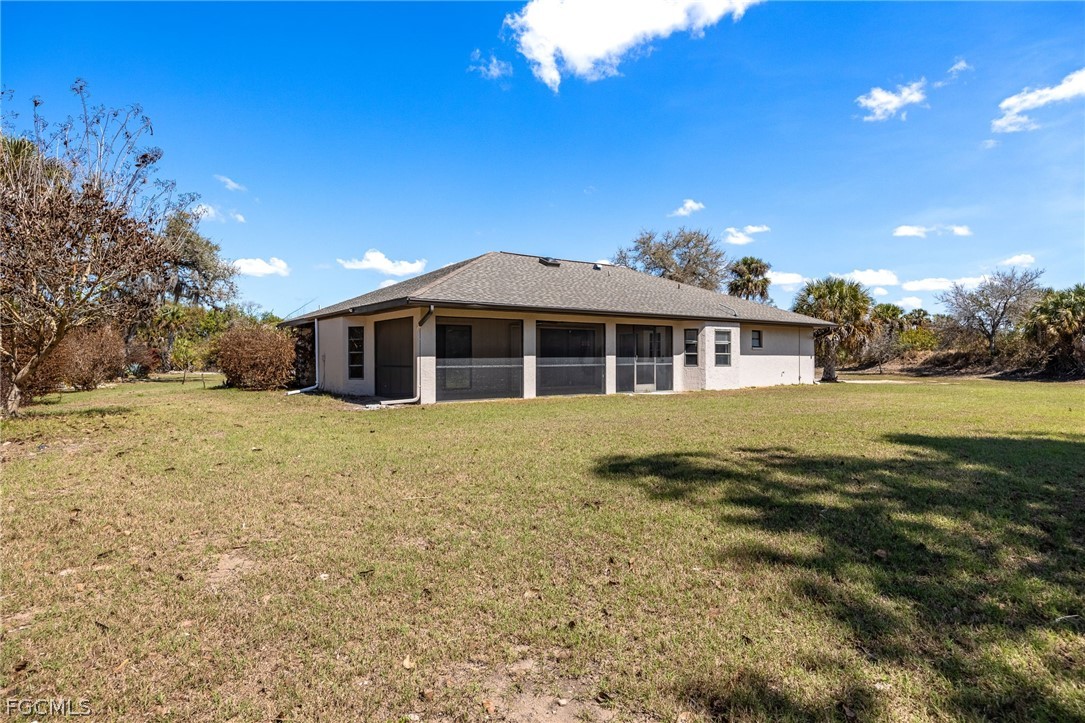 18890 Fox Run Road Alva, FL 33920 - Photo 30 of 50 a front view of a house with a yard
