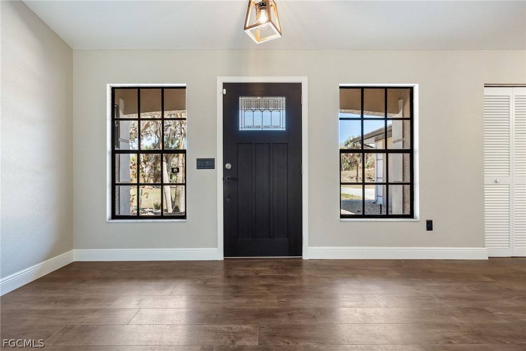 18890 Fox Run Road Alva, FL 33920 - Photo 3 of 50 a view of an empty room with wooden floor and a window