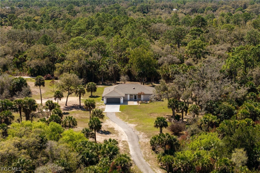 18890 Fox Run Road Alva, FL 33920 - Photo 39 of 50 an aerial view of a house with a yard swimming pool and outdoor seating