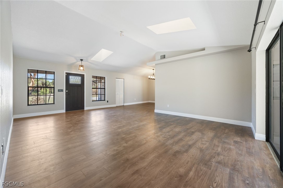 18890 Fox Run Road Alva, FL 33920 - Photo 6 of 50 a view of an empty room with window and wooden floor