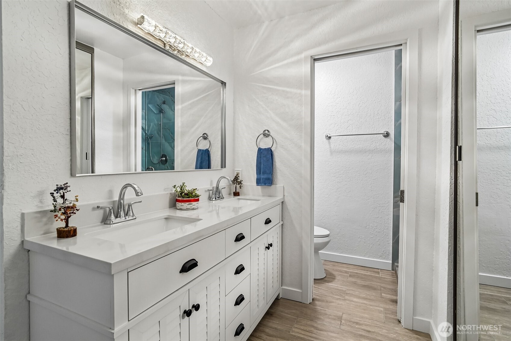 14401 Southeast Petrovitsky Road, Unit D205 Renton, WA 98058 - Photo 15 of 32 a bathroom with a double vanity sink and a mirror