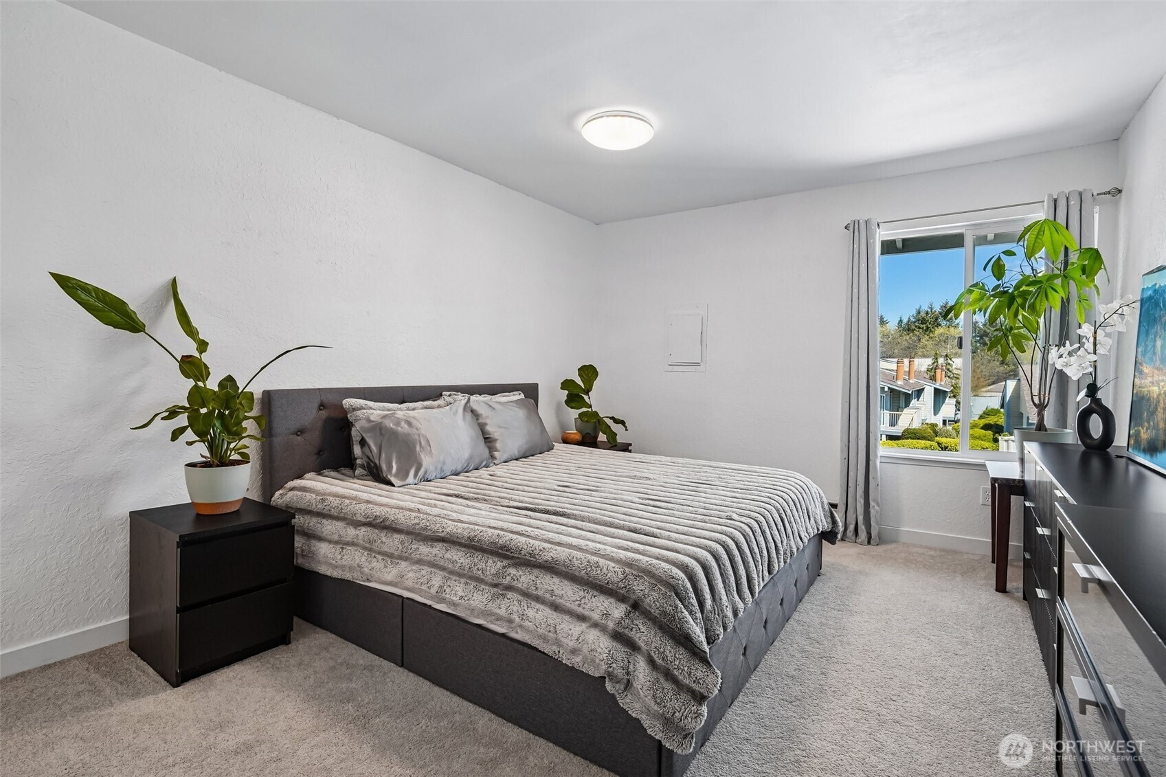 14401 Southeast Petrovitsky Road, Unit D205 Renton, WA 98058 - Photo 19 of 32 a bedroom with bed and a potted plant