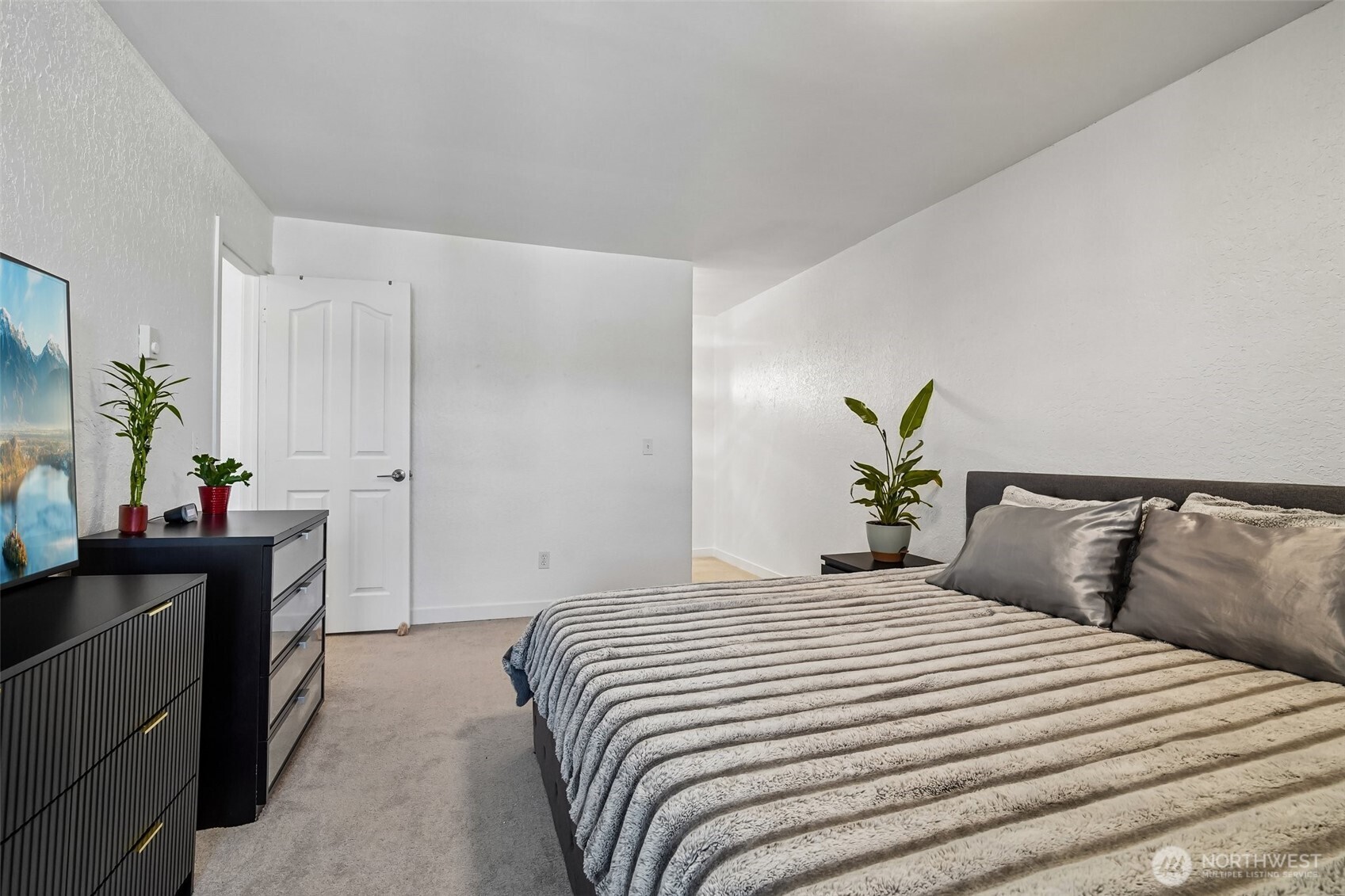 14401 Southeast Petrovitsky Road, Unit D205 Renton, WA 98058 - Photo 20 of 32 a bedroom with a bed and a potted plant