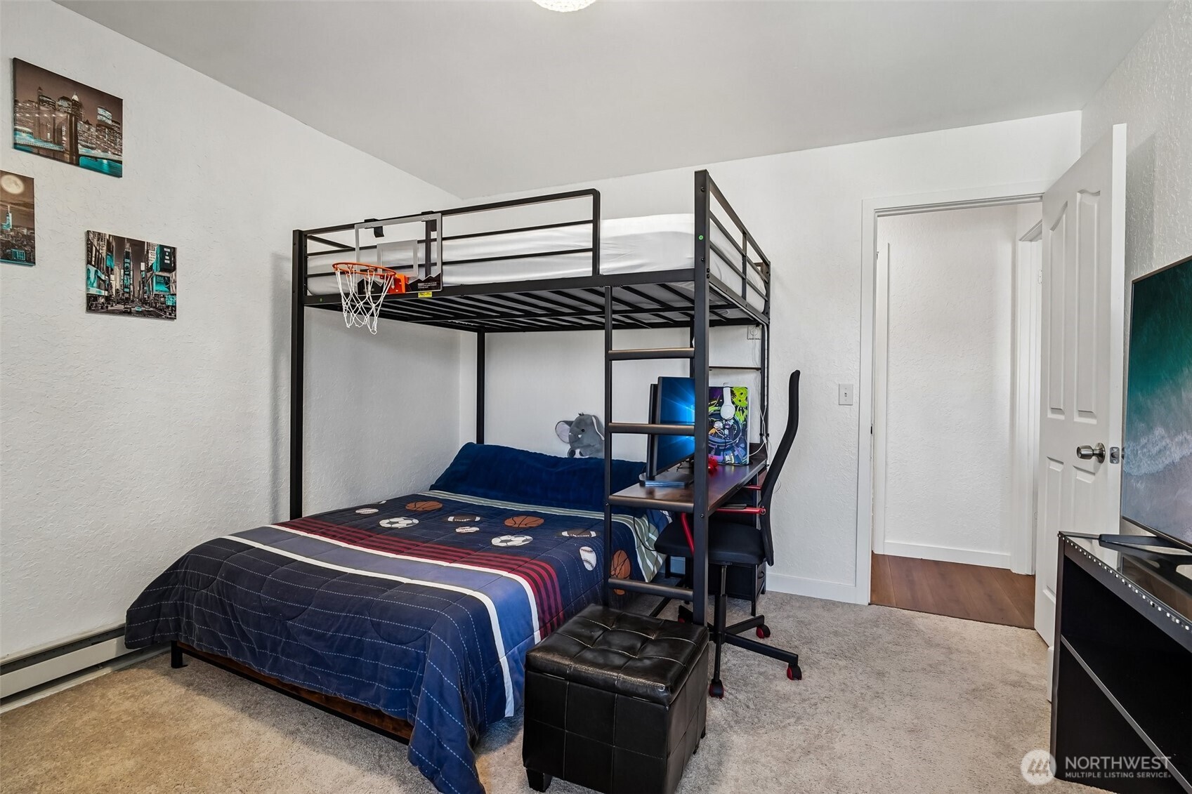 14401 Southeast Petrovitsky Road, Unit D205 Renton, WA 98058 - Photo 22 of 32 a bedroom with a bed a flat tv screen and a bookshelf