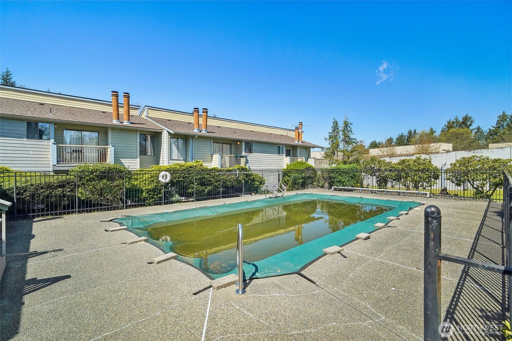 14401 Southeast Petrovitsky Road, Unit D205 Renton, WA 98058 - Photo 29 of 32 a view of a house with swimming pool