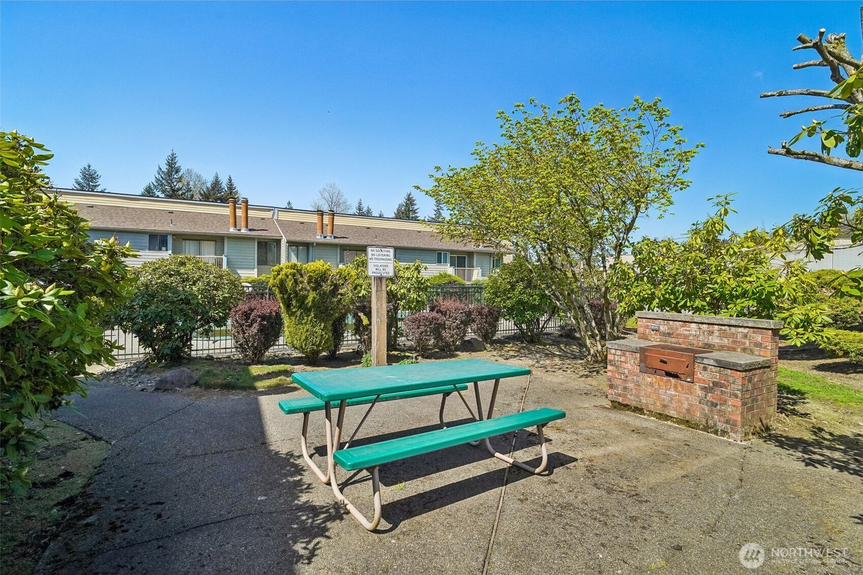 14401 Southeast Petrovitsky Road, Unit D205 Renton, WA 98058 - Photo 31 of 32 a view of a bench in a backyard