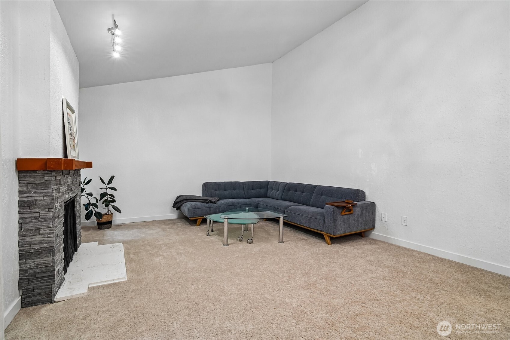 14401 Southeast Petrovitsky Road, Unit D205 Renton, WA 98058 - Photo 6 of 32 a room with a couch and a chandelier