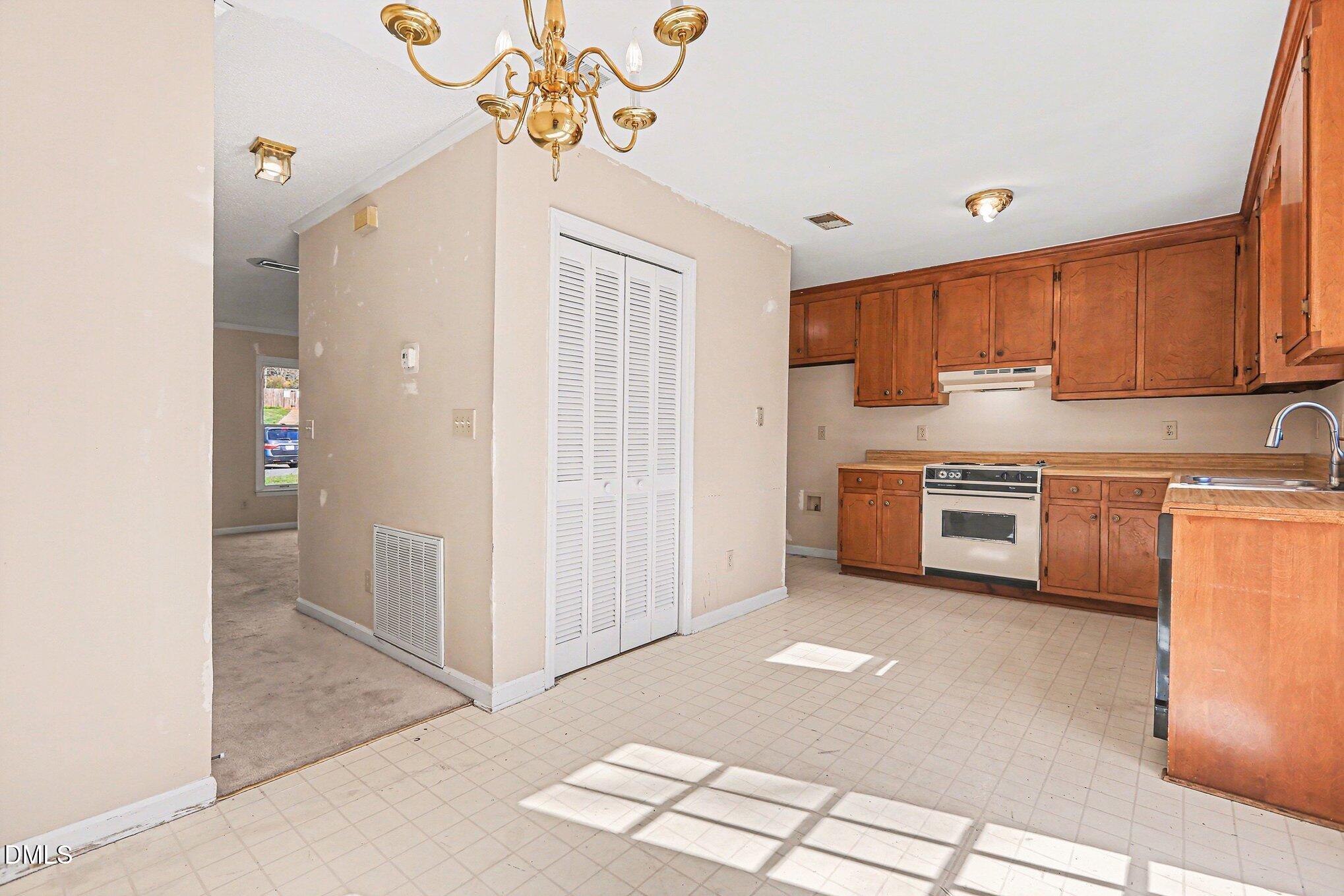 1812 Orange Grove Road, Unit 118 Hillsborough, NC 27278 - Photo 11 of 28 a kitchen that has a lot of cabinets in it