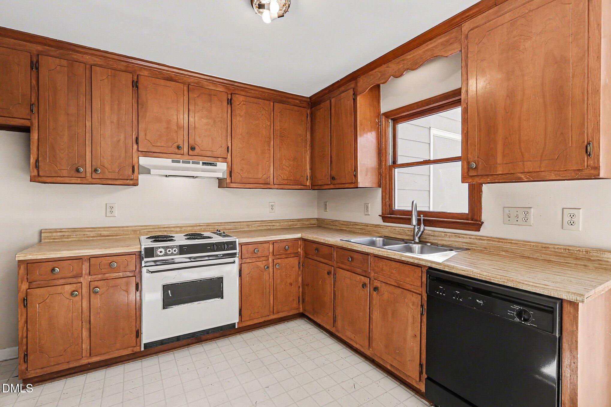 1812 Orange Grove Road, Unit 118 Hillsborough, NC 27278 - Photo 12 of 28 a kitchen with stainless steel appliances granite countertop a sink stove and cabinets
