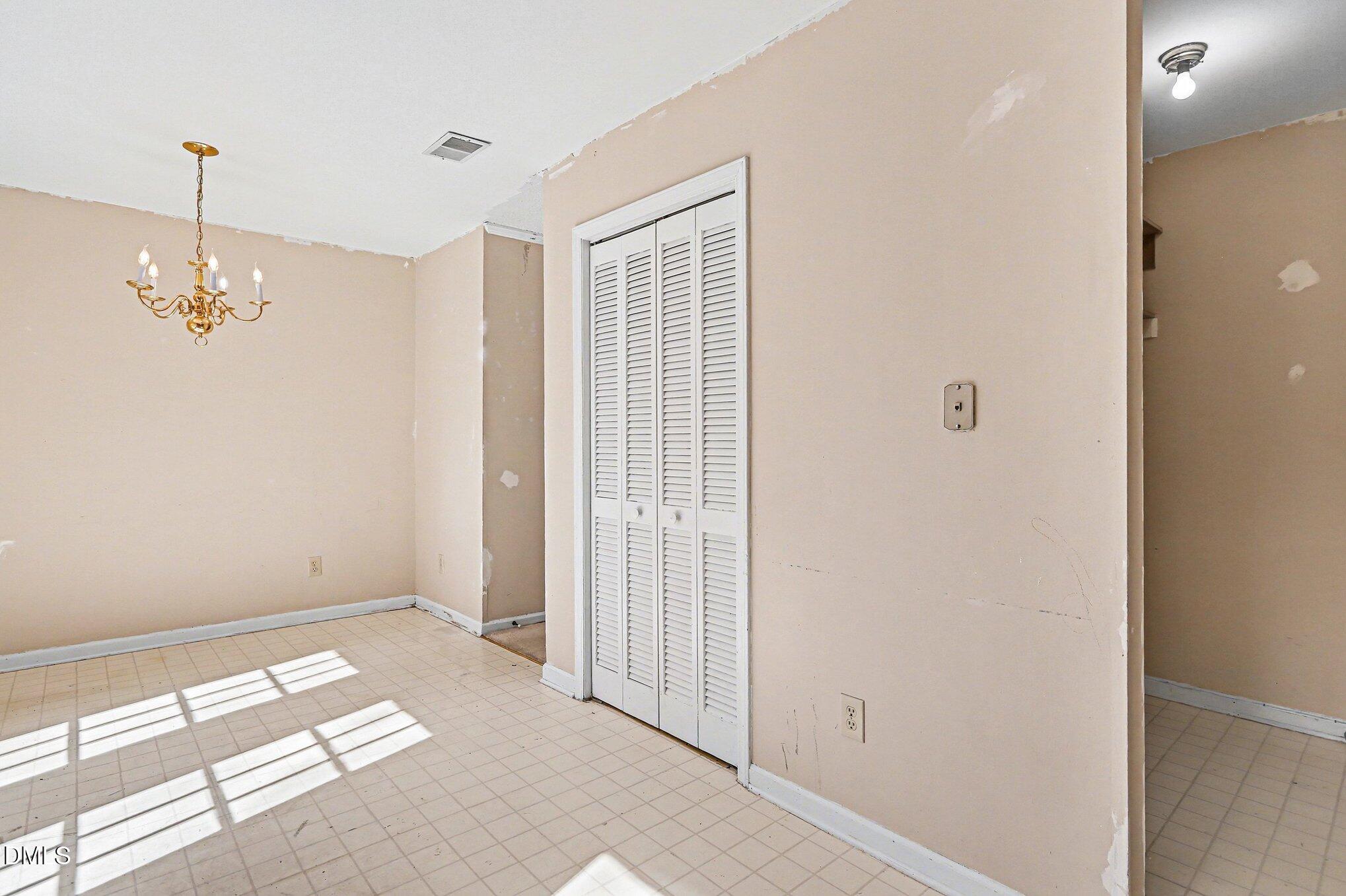 1812 Orange Grove Road, Unit 118 Hillsborough, NC 27278 - Photo 14 of 28 a view of a room with a chandelier fan and a window