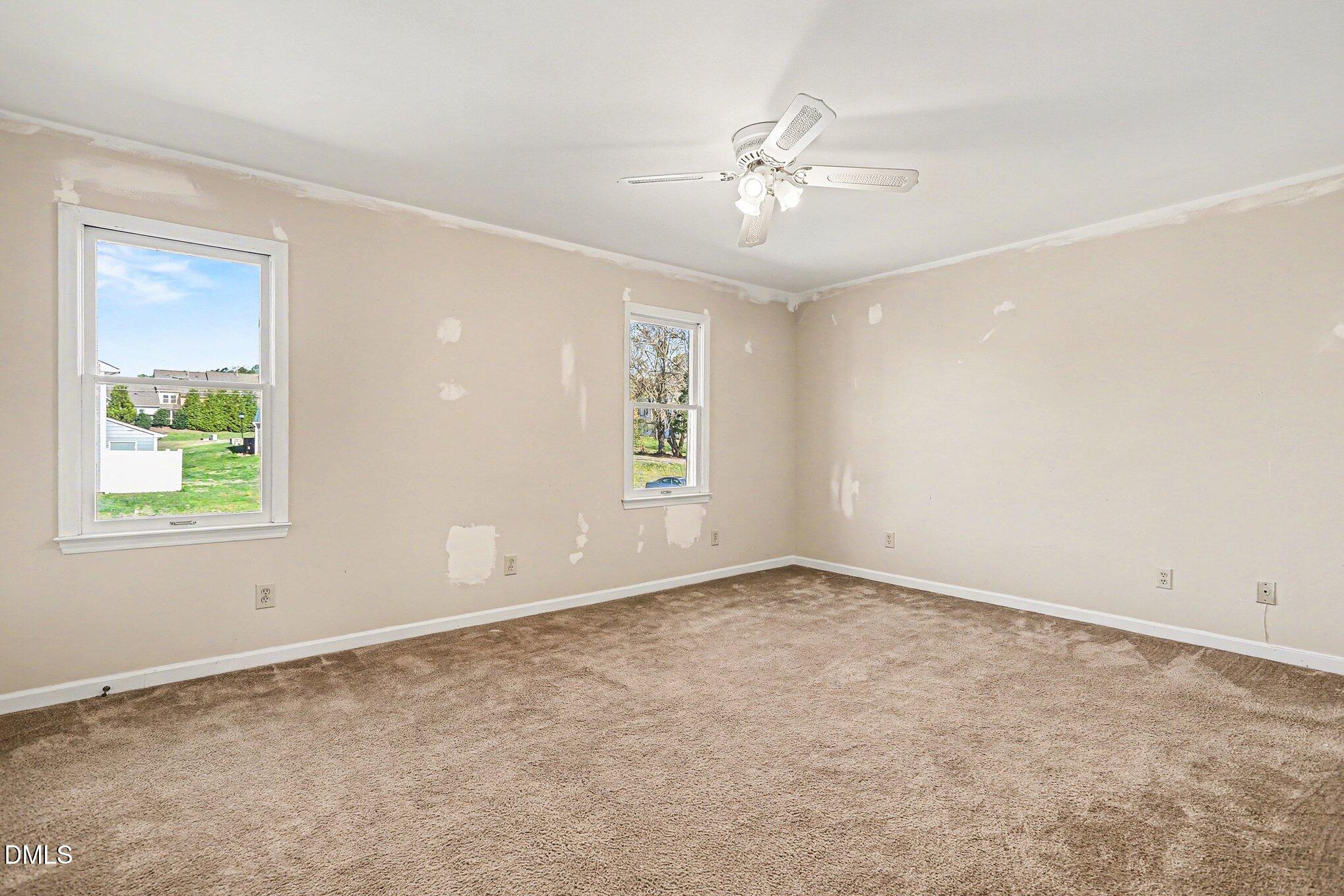 1812 Orange Grove Road, Unit 118 Hillsborough, NC 27278 - Photo 16 of 28 an empty room with windows and chandelier fan
