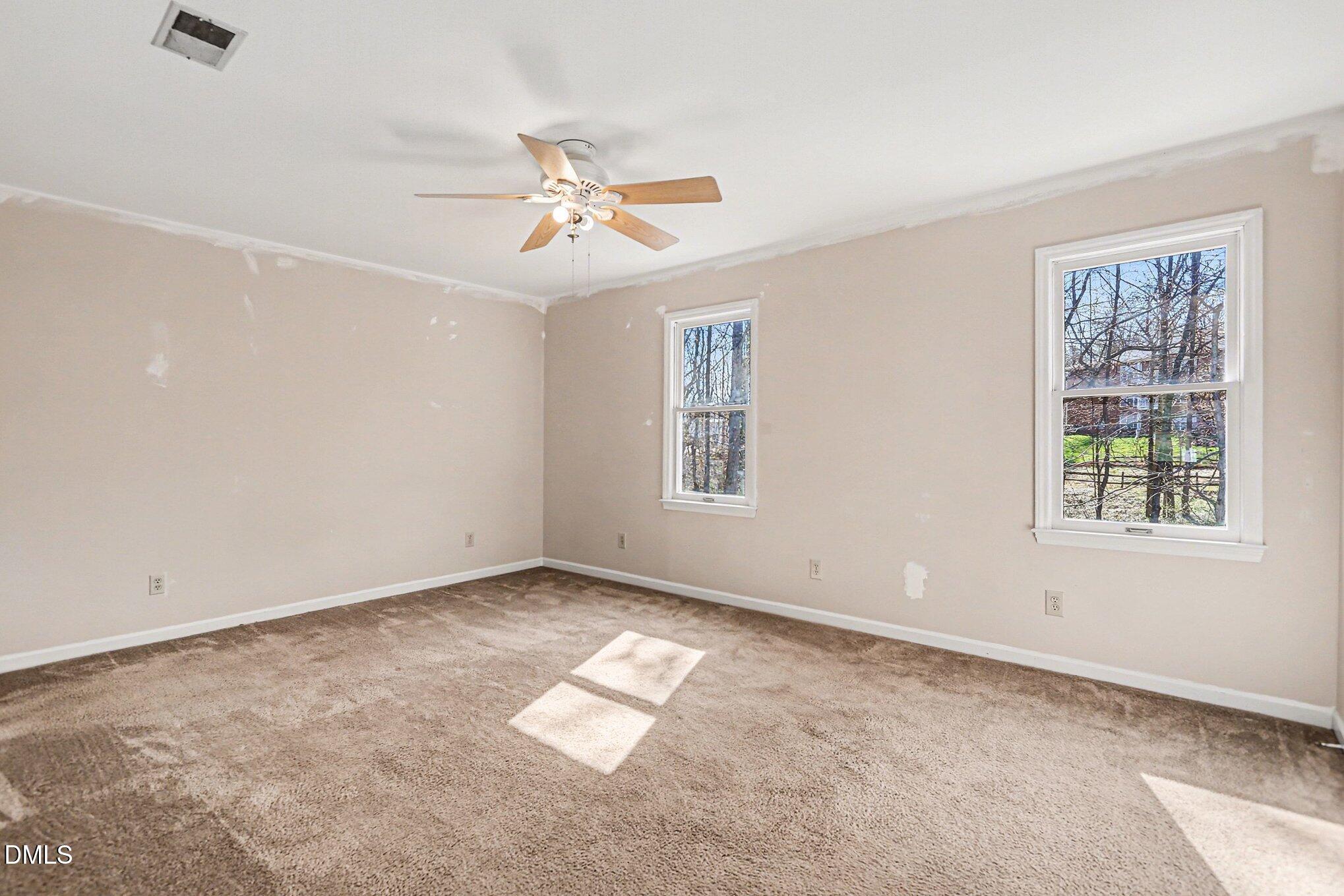 1812 Orange Grove Road, Unit 118 Hillsborough, NC 27278 - Photo 17 of 28 an empty room with windows and fan
