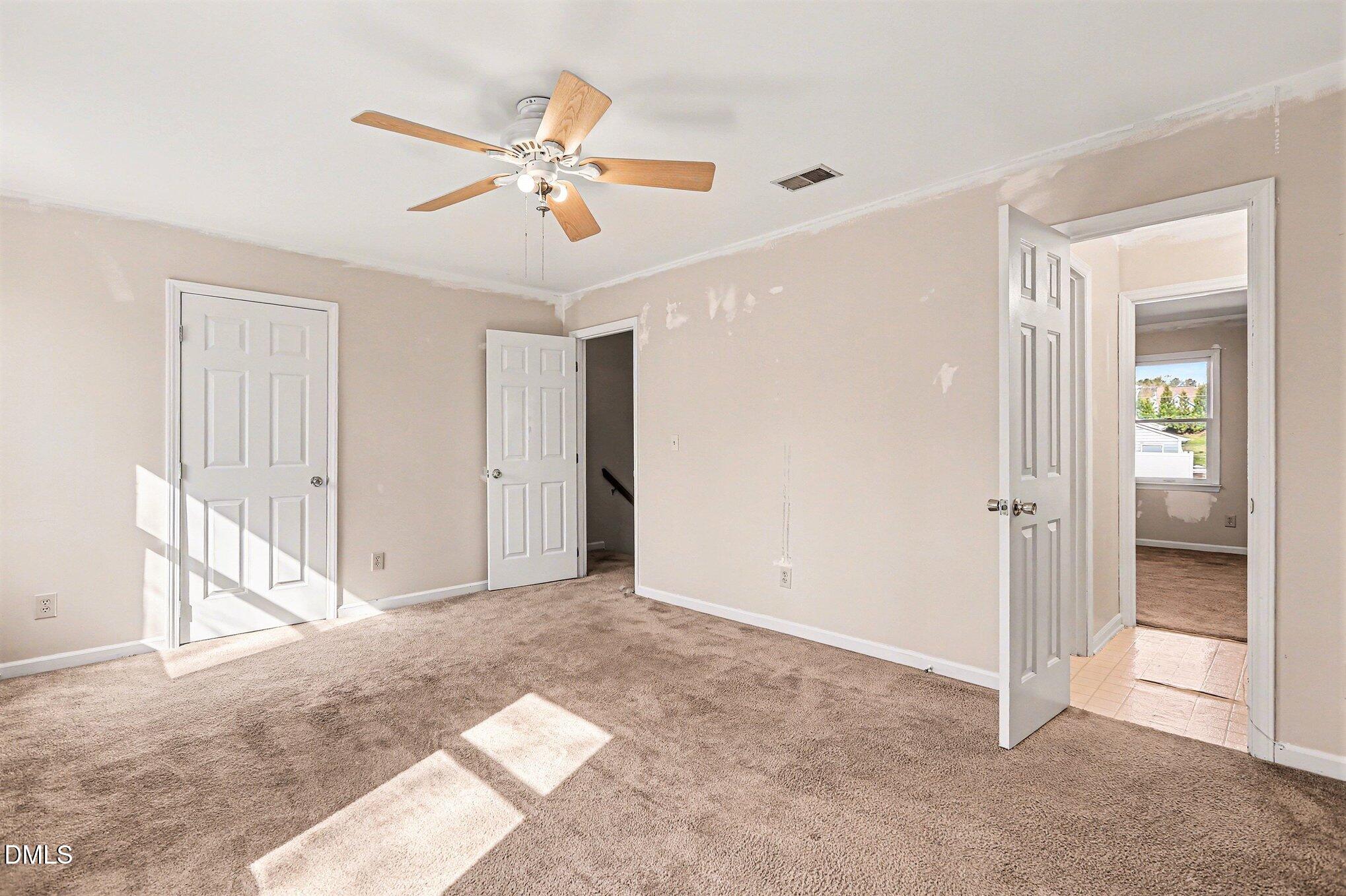 1812 Orange Grove Road, Unit 118 Hillsborough, NC 27278 - Photo 19 of 28 a view of an empty room with a ceiling fan
