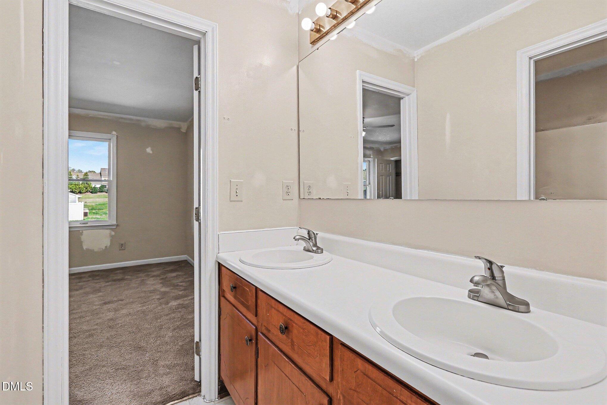 1812 Orange Grove Road, Unit 118 Hillsborough, NC 27278 - Photo 21 of 28 a bathroom with a sink and a mirror