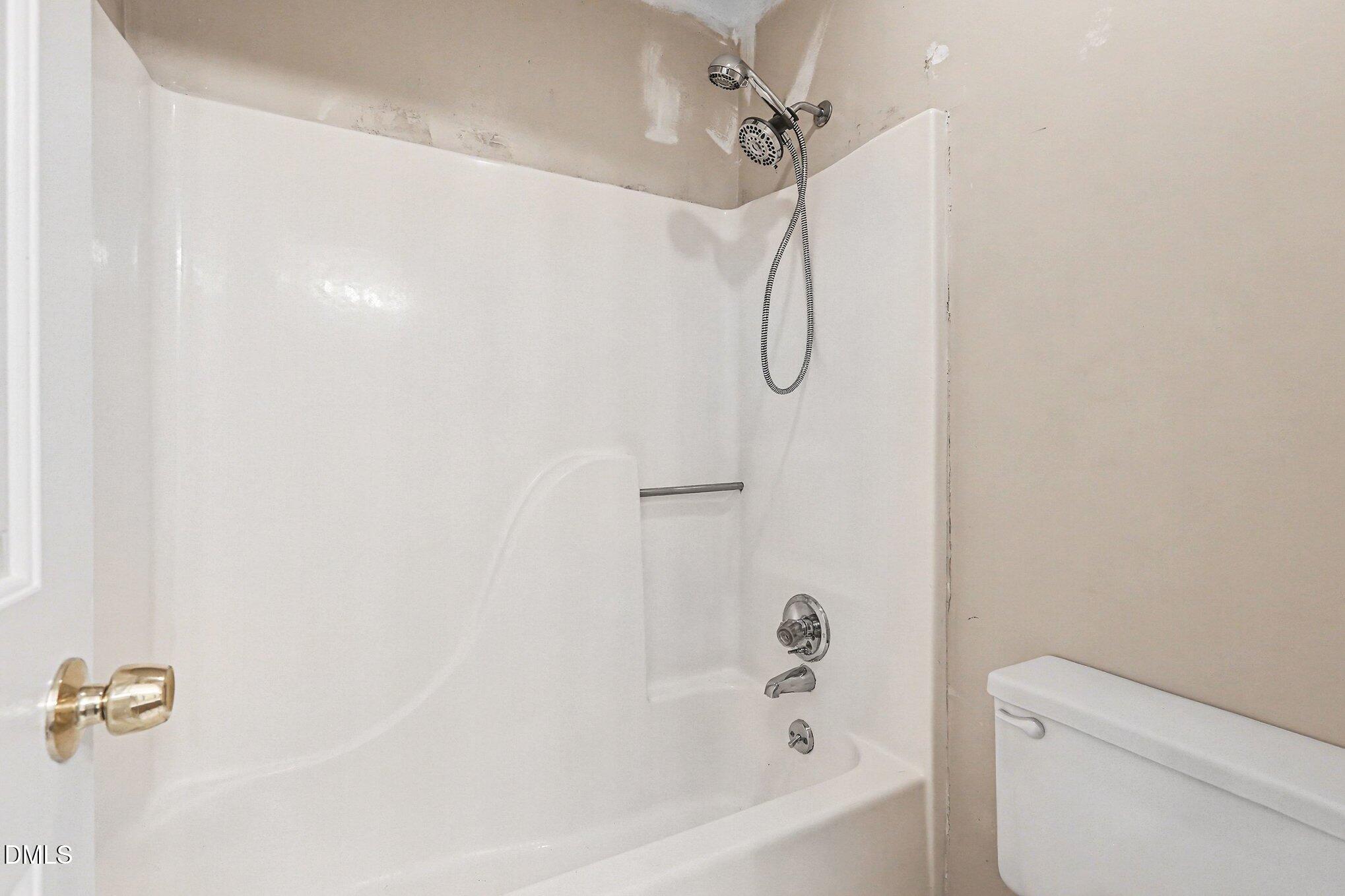 1812 Orange Grove Road, Unit 118 Hillsborough, NC 27278 - Photo 22 of 28 a bathroom with a bath tub with a shower