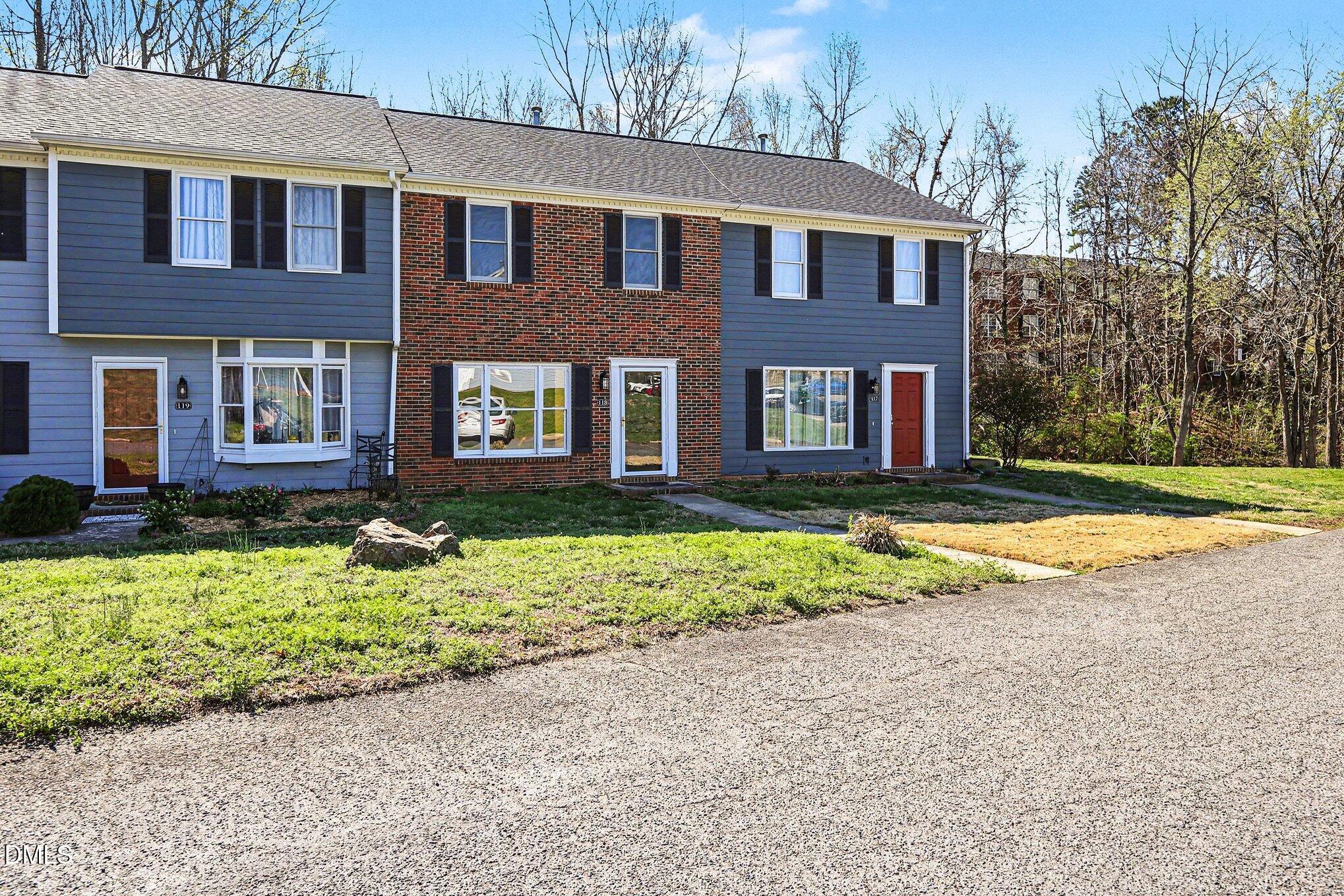 1812 Orange Grove Road, Unit 118 Hillsborough, NC 27278 - Photo 25 of 28 a front view of a house with a yard