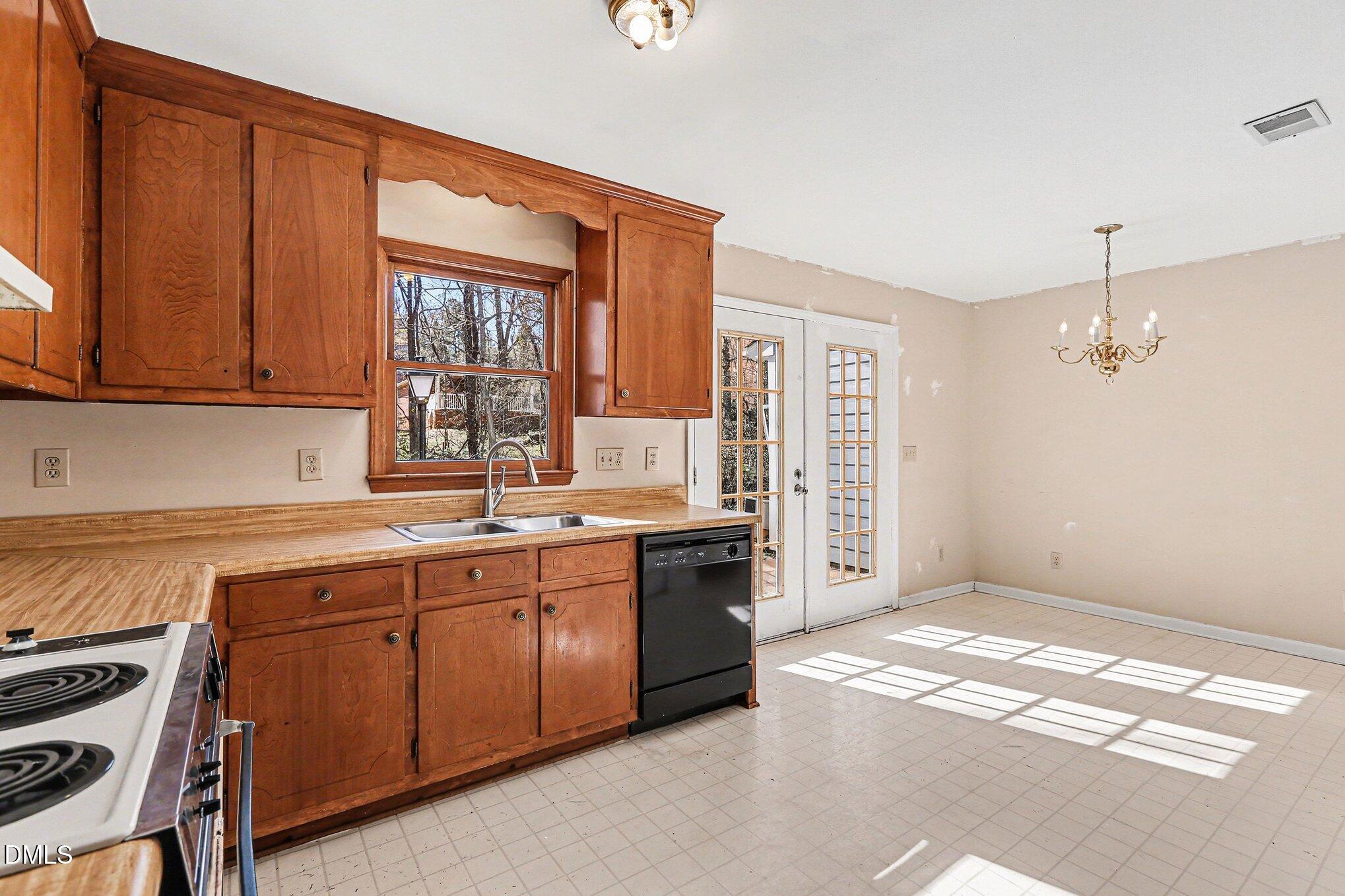 1812 Orange Grove Road, Unit 118 Hillsborough, NC 27278 - Photo 7 of 28 a open kitchen with a sink stove and cabinets