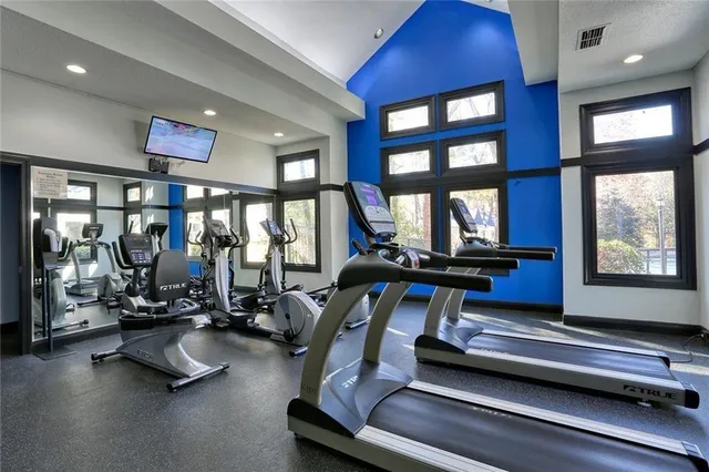a room with gym equipment and floor to ceiling window