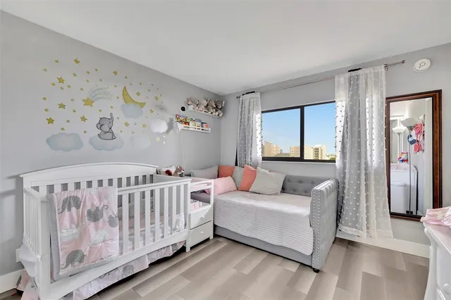 a living room with furniture and a baby crib