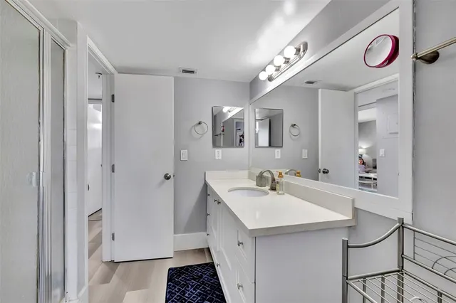 a spacious bathroom with a sink and a mirror